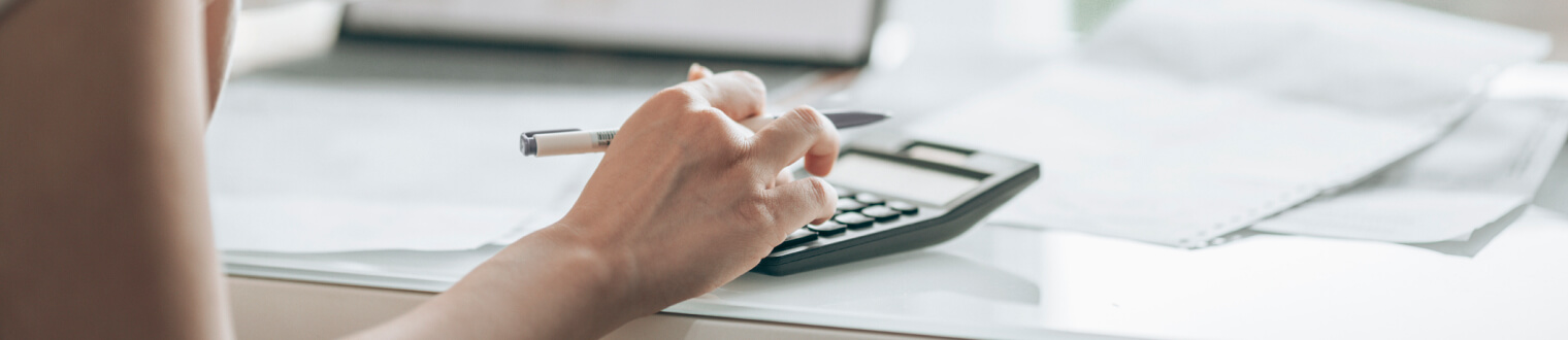 Close-up of a person's hands using a calculator