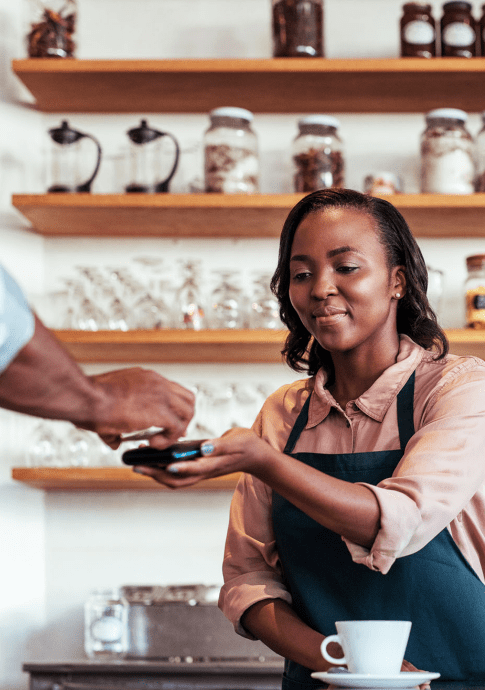 Women coffee shop business owner taking a mobile payment.