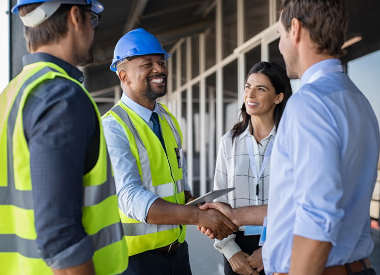 Group of business people and contractors standing in a build site