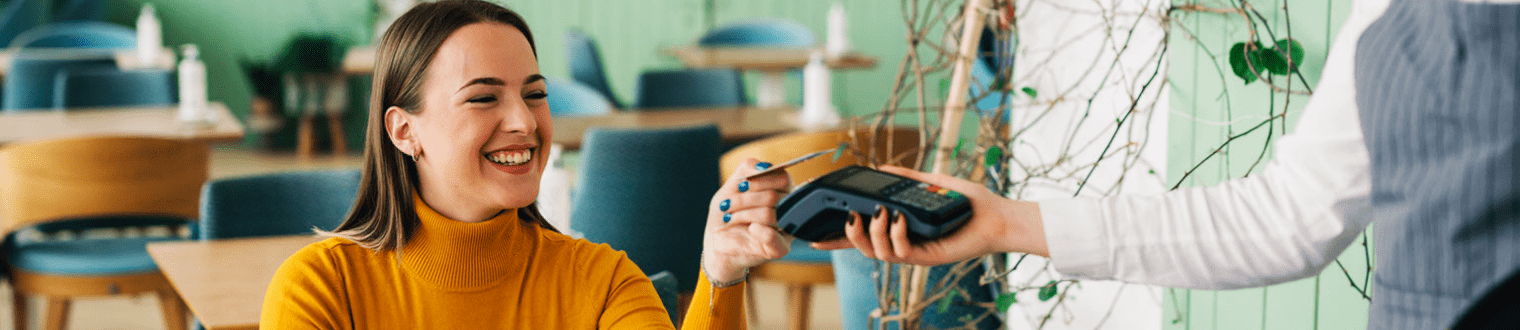 woman paying bill contactless with debit card