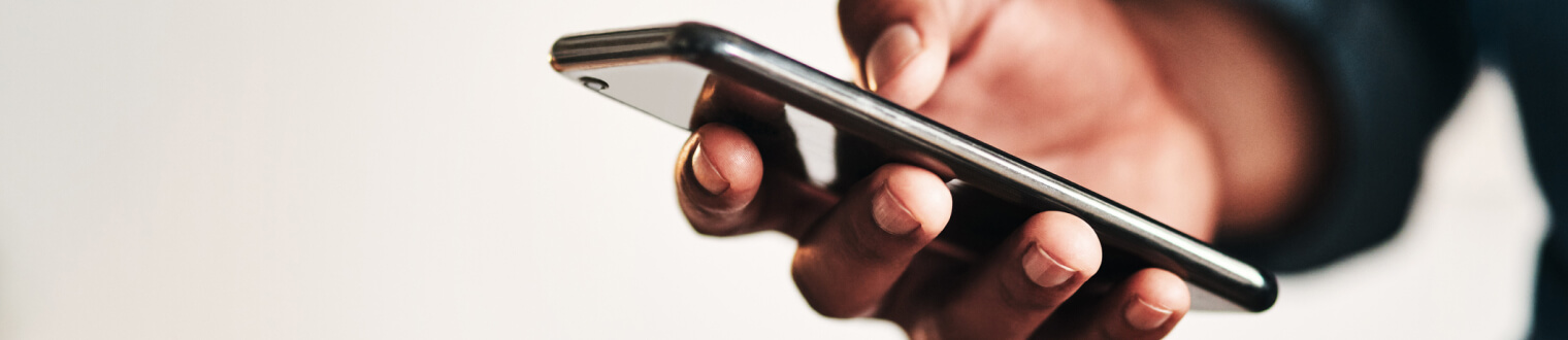 Close-up of a person's hand holding smartphone