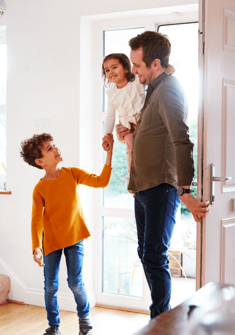 Father Returning Home After Trip Out With Excited Children Running Ahead